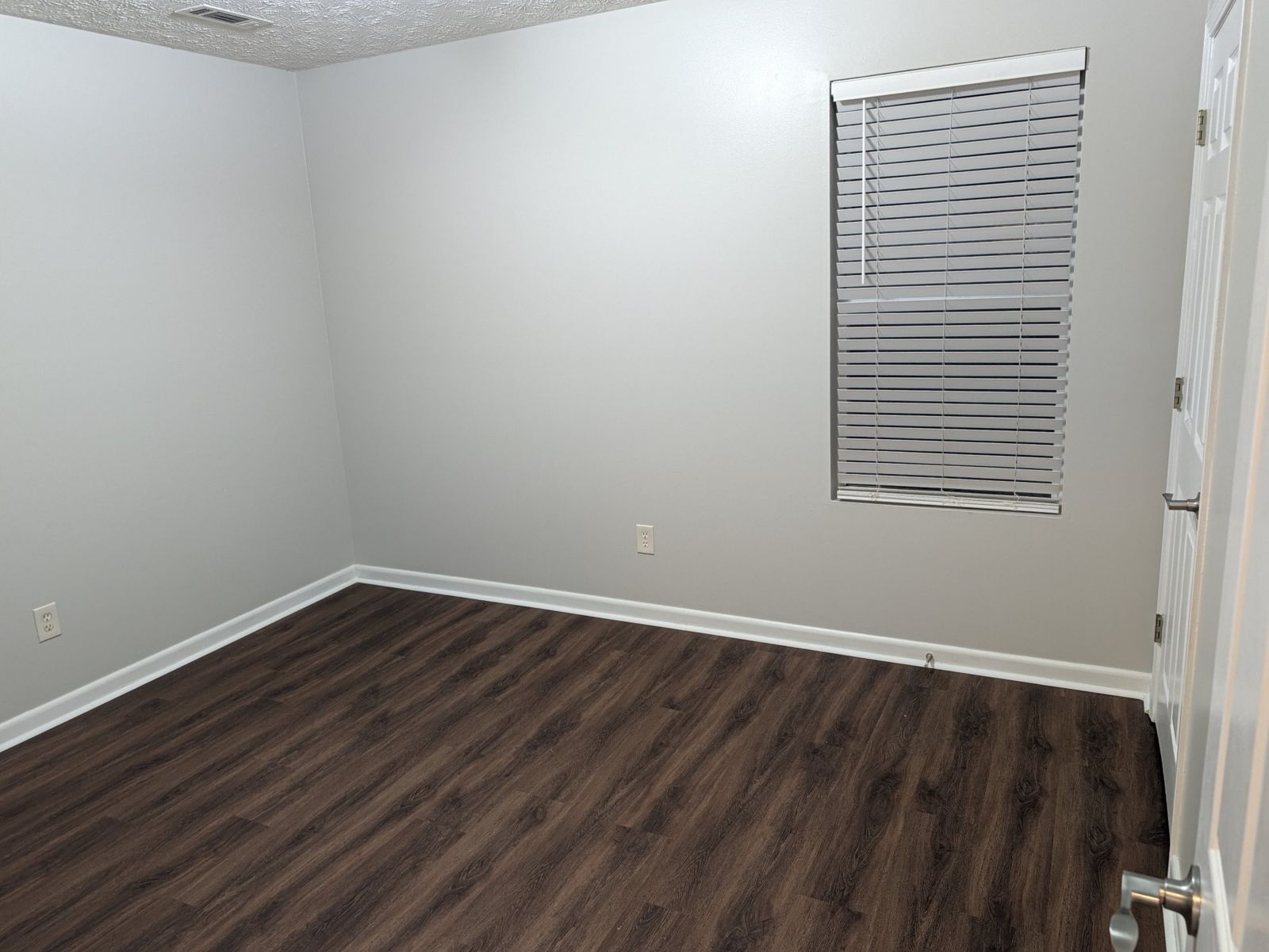Bedroom with window and blinds