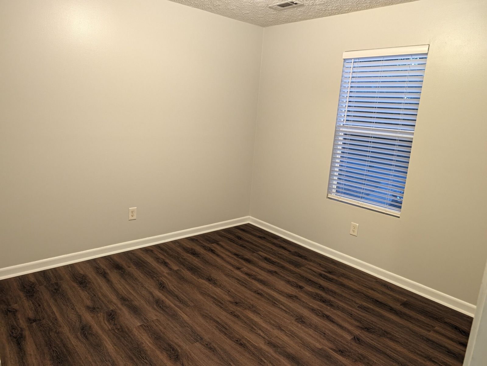 Bedroom with window and blinds