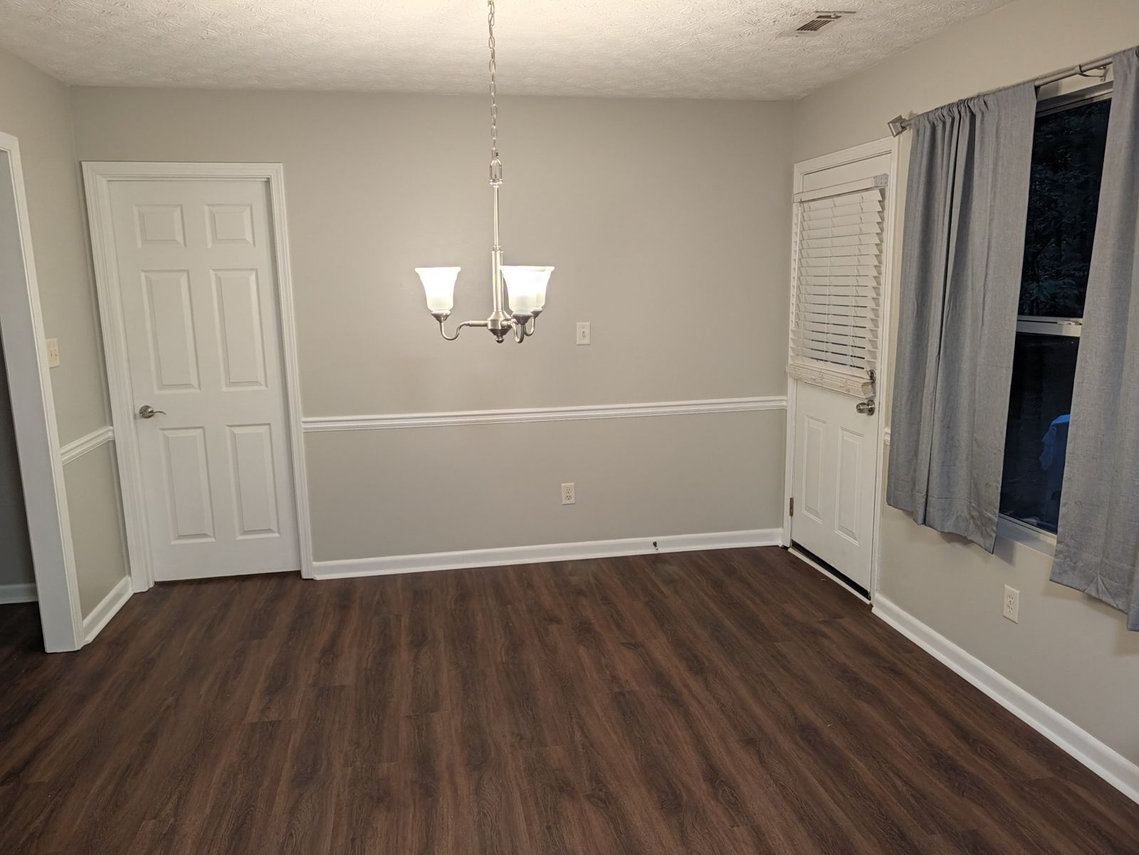 Dining room with chandelier and chair rail