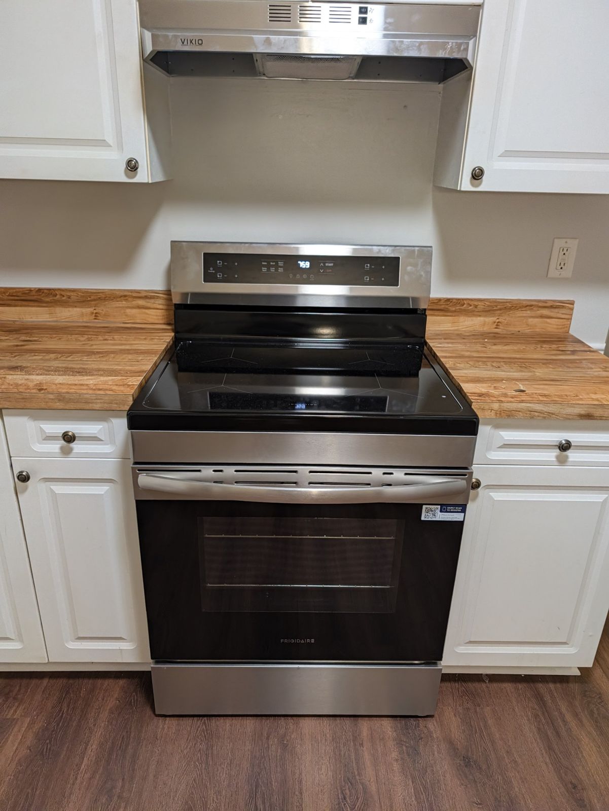 Stainless induction range under a range hood